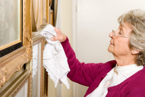 Elderly woman dusting - Senior Care in Los Angeles